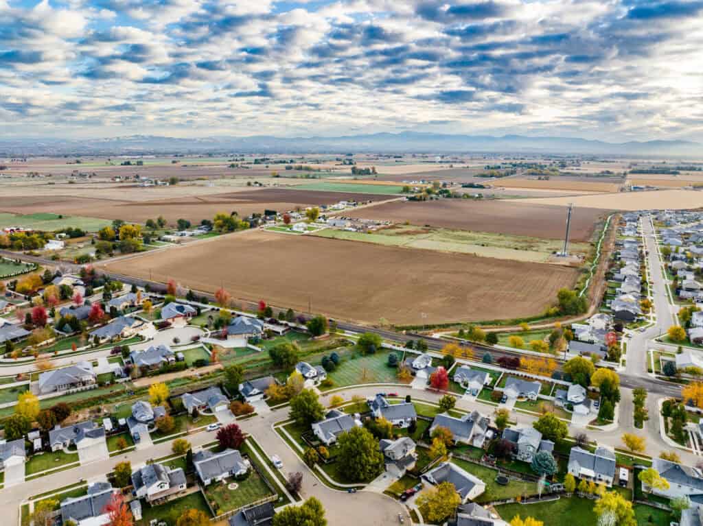 Scenic view of Boise city with fall foliage and river in foreground.