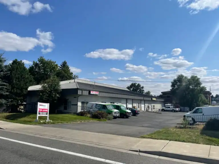 Commercial building with parking lot and 'For Lease' sign in Spokane.