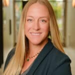 Portrait of Chelsey Keim, smiling woman with long blonde hair in professional setting.