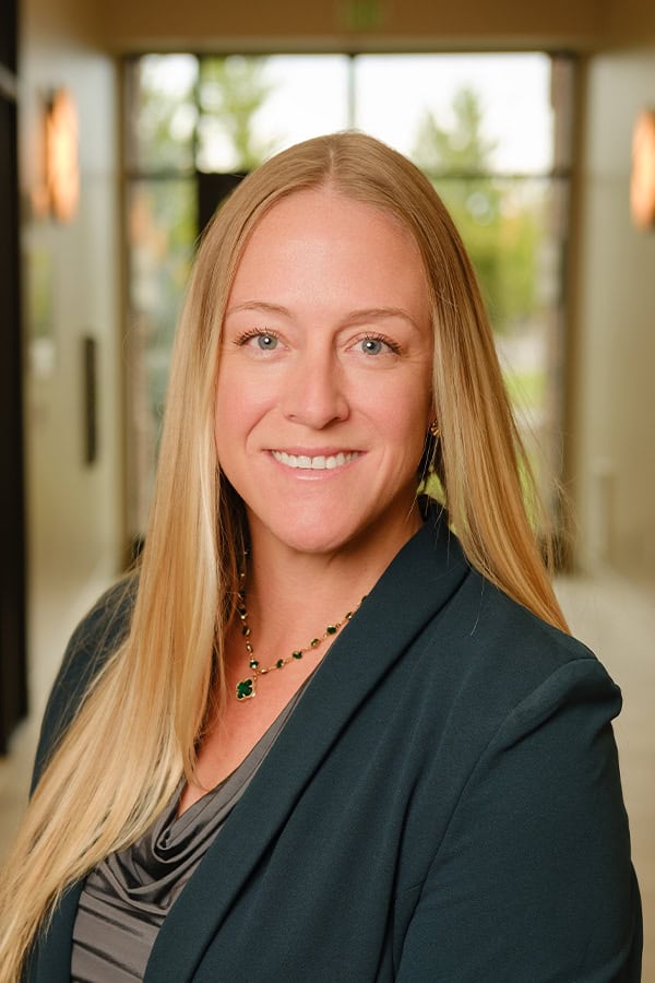 Portrait of Chelsey Keim, smiling woman with long blonde hair in professional setting.