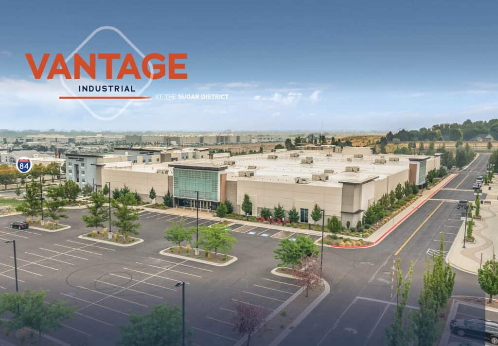 Vantage Industrial warehouse in Nampa Idaho with parking lot and trees.